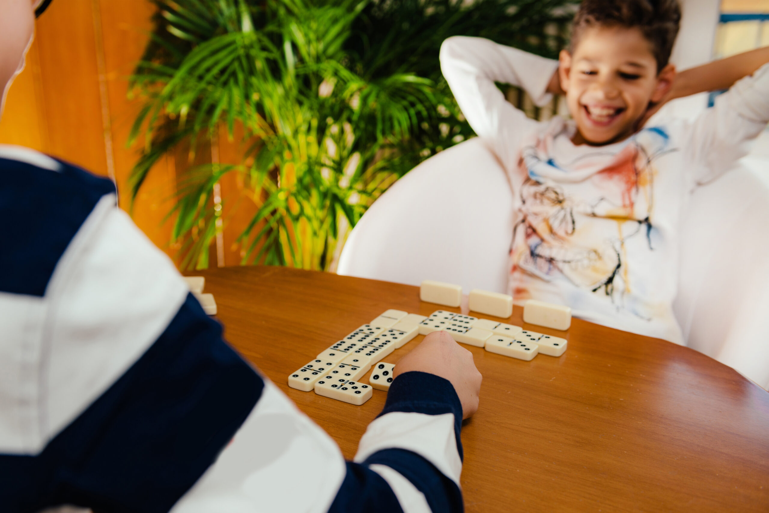 Boy playing dominoes at home.